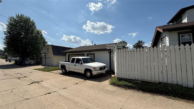 419 21st St NE, Cedar Rapids, IA 52402 - view of side of property featuring an attached garage and concrete driveway