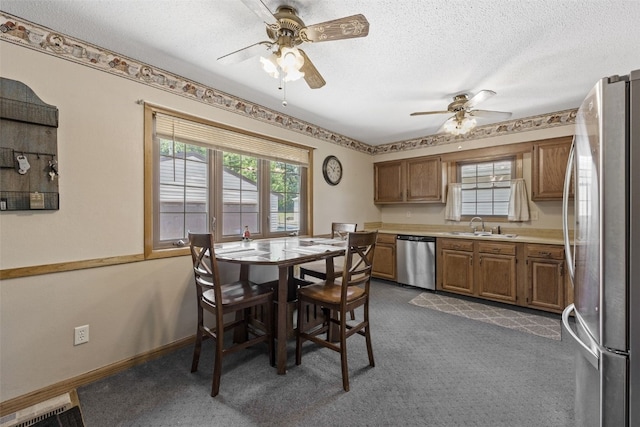 2540 Lori Dr SW, Cedar Rapids, IA 52404 - dining room featuring a ceiling fan, dark carpet, and a textured ceiling