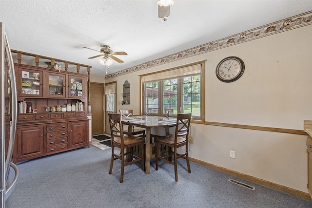 2540 Lori Dr SW, Cedar Rapids, IA 52404 - dining room featuring ceiling fan, carpet, and a textured ceiling