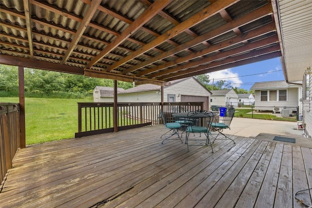 2540 Lori Dr SW, Cedar Rapids, IA 52404 - wooden deck with an outbuilding, a lawn, and outdoor dining area