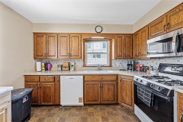 2469 1st St SW, Cedar Rapids, IA 52404 - kitchen featuring white appliances, tasteful backsplash, light countertops, and brown cabinetry