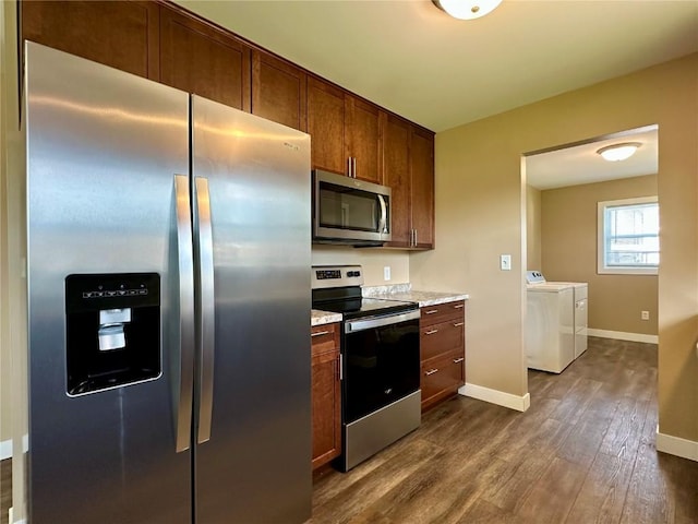 3025 4th Ave, Marion, IA 52302 - kitchen featuring appliances with stainless steel finishes, washing machine and clothes dryer, and dark wood-type flooring