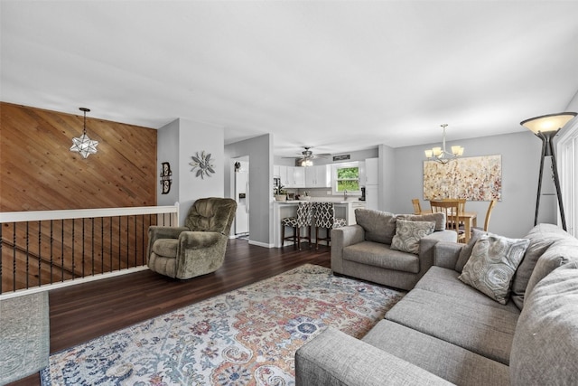 1428 Timber Ridge Trl NE, Solon, IA 52333 - living area with dark wood-style flooring, a chandelier, ceiling fan, and wooden walls