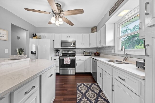 1428 Timber Ridge Trl NE, Solon, IA 52333 - kitchen with stainless steel appliances, white cabinetry, backsplash, and dark wood-type flooring