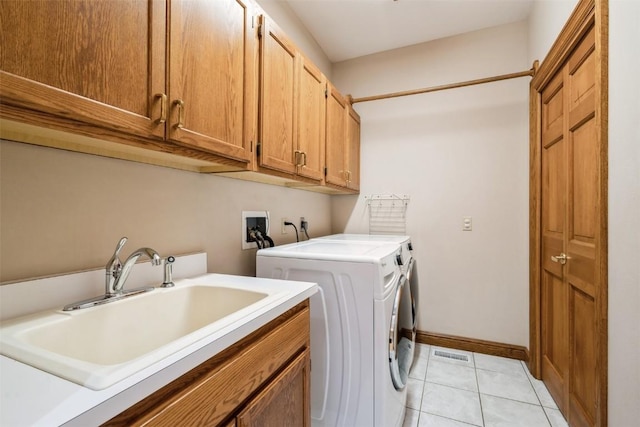 3519 Timber Ridge Trl NE, Cedar Rapids, IA 52411 - laundry area with cabinet space, independent washer and dryer, and light tile patterned floors