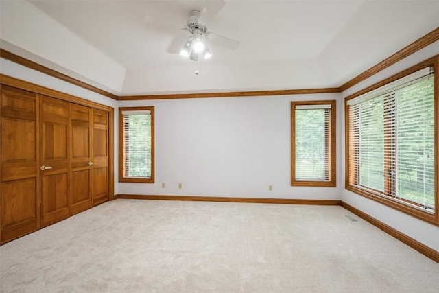 3519 Timber Ridge Trl NE, Cedar Rapids, IA 52411 - unfurnished bedroom with carpet, multiple windows, a raised ceiling, and crown molding