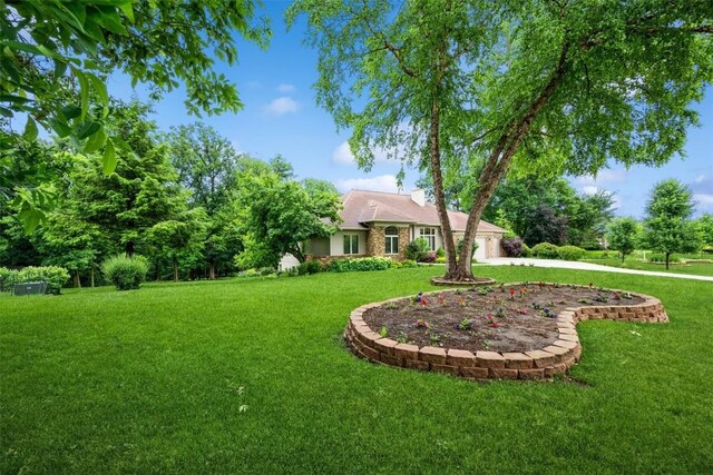 3519 Timber Ridge Trl NE, Cedar Rapids, IA 52411 - view of green lawn featuring a garage and concrete driveway