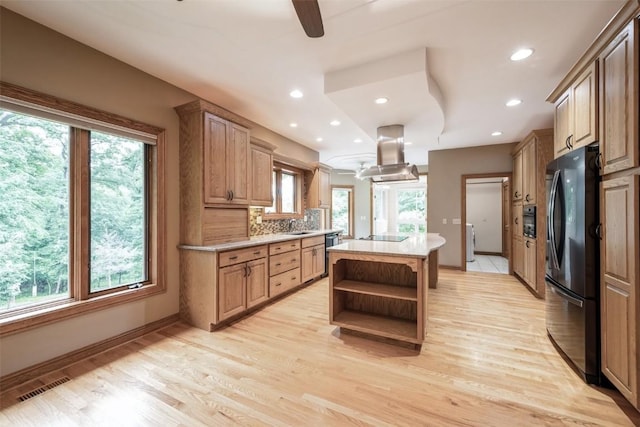3519 Timber Ridge Trl NE, Cedar Rapids, IA 52411 - kitchen with island range hood, freestanding refrigerator, open shelves, a kitchen island, and plenty of natural light