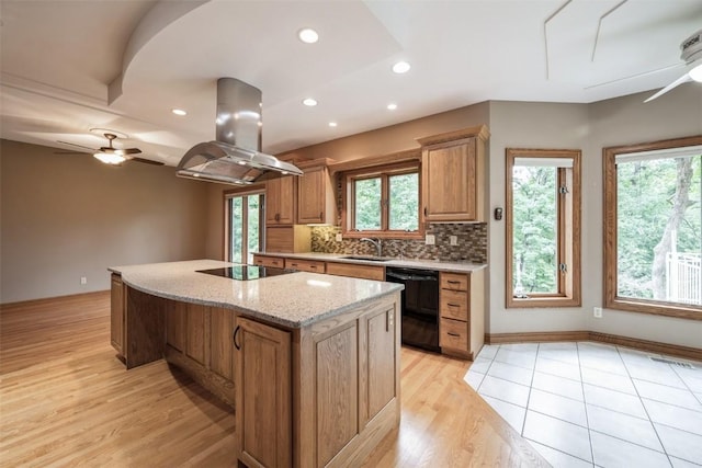 3519 Timber Ridge Trl NE, Cedar Rapids, IA 52411 - kitchen with black appliances, island range hood, ceiling fan, a kitchen island, and light wood-style floors