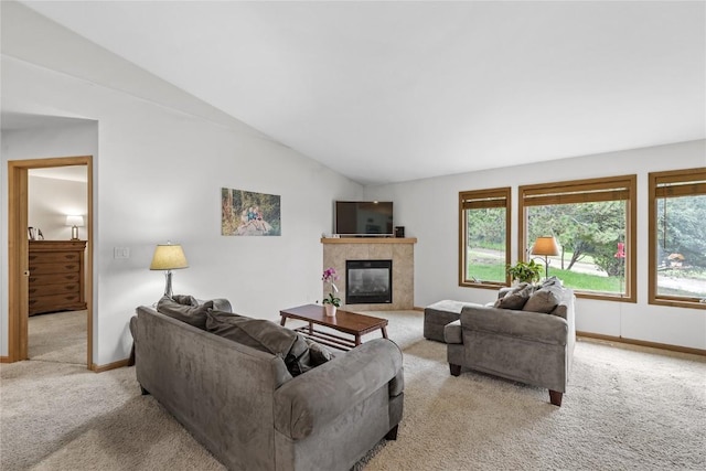664 J Ave NE Unit A, Cedar Rapids, IA 52402 - living area with light carpet, lofted ceiling, healthy amount of natural light, and a tile fireplace