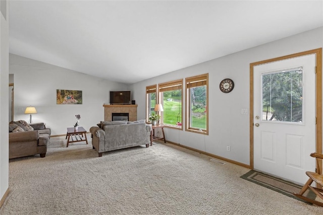 664 J Ave NE Unit A, Cedar Rapids, IA 52402 - living room with carpet floors, a tile fireplace, and lofted ceiling