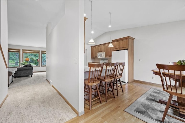 664 J Ave NE Unit A, Cedar Rapids, IA 52402 - dining space featuring lofted ceiling and light wood-style floors
