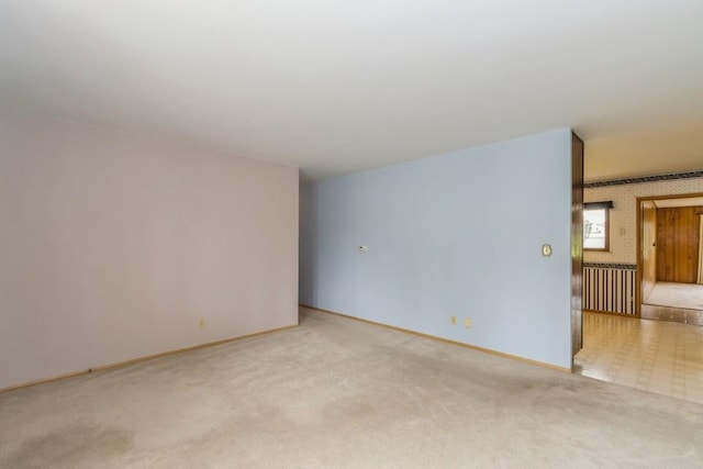 5660 Briarwood St SW, Cedar Rapids, IA 52401 - spare room with wallpapered walls and light colored carpet