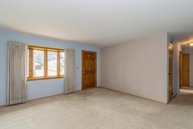 5660 Briarwood St SW, Cedar Rapids, IA 52401 - spare room featuring light colored carpet and baseboards