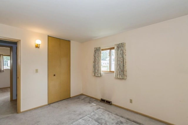 5660 Briarwood St SW, Cedar Rapids, IA 52401 - unfurnished bedroom featuring light colored carpet and a closet