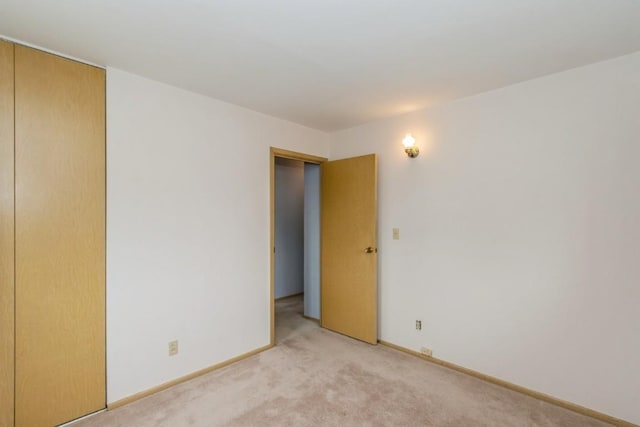 5660 Briarwood St SW, Cedar Rapids, IA 52401 - unfurnished room featuring light carpet and baseboards