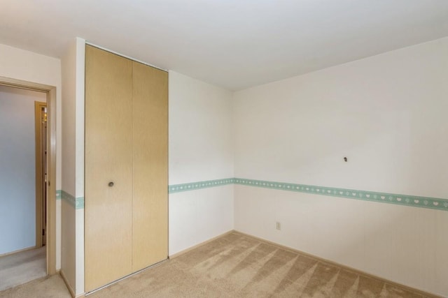 5660 Briarwood St SW, Cedar Rapids, IA 52401 - spare room featuring light colored carpet