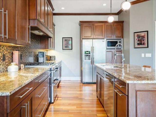 4390 Flagstick Dr, Marion, IA 52302 - kitchen with appliances with stainless steel finishes, ornamental molding, light wood-style floors, tasteful backsplash, and light stone countertops