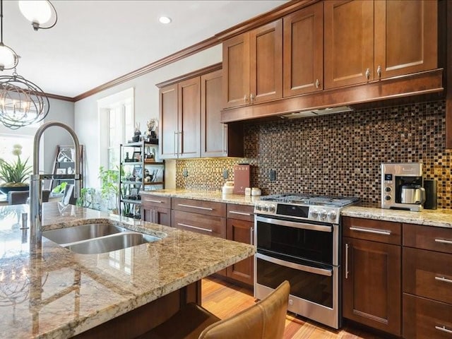 4390 Flagstick Dr, Marion, IA 52302 - kitchen with double oven range, light stone countertops, ornamental molding, backsplash, and recessed lighting