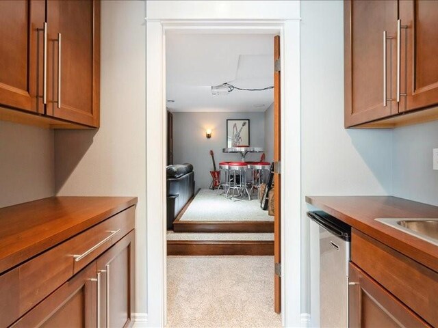 4390 Flagstick Dr, Marion, IA 52302 - kitchen featuring dishwasher, brown cabinets, and carpet