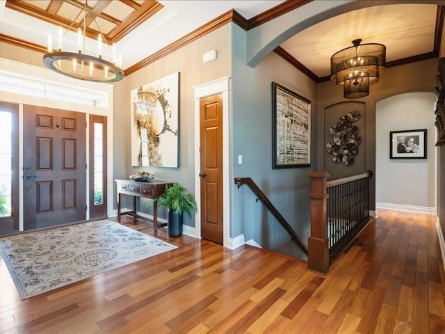 4390 Flagstick Dr, Marion, IA 52302 - entryway with a chandelier, arched walkways, wood finished floors, ornamental molding, and coffered ceiling