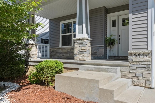 3076 Lower W Branch Rd, Iowa City, IA 52245 - doorway to property featuring stone siding and a porch