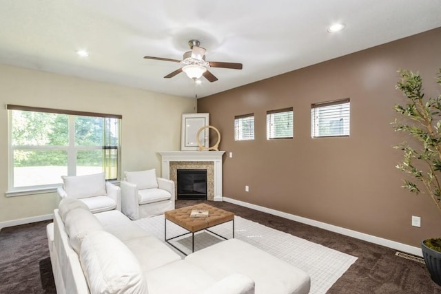 3076 Lower W Branch Rd, Iowa City, IA 52245 - living area with dark colored carpet, a ceiling fan, a glass covered fireplace, and recessed lighting