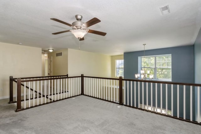 3076 Lower W Branch Rd, Iowa City, IA 52245 - unfurnished room with carpet, a chandelier, and a ceiling fan