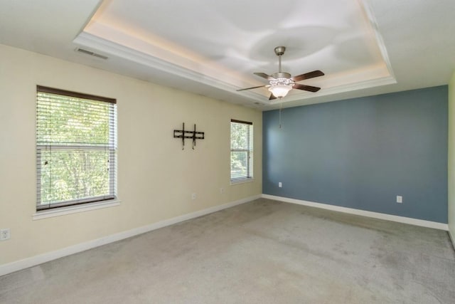 3076 Lower W Branch Rd, Iowa City, IA 52245 - spare room featuring a raised ceiling, carpet flooring, and ceiling fan