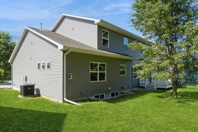 3076 Lower W Branch Rd, Iowa City, IA 52245 - back of property with a lawn, a wooden deck, and a shingled roof