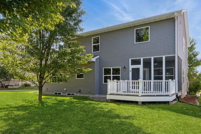 3076 Lower W Branch Rd, Iowa City, IA 52245 - rear view of house featuring a lawn, a wooden deck, and a sunroom