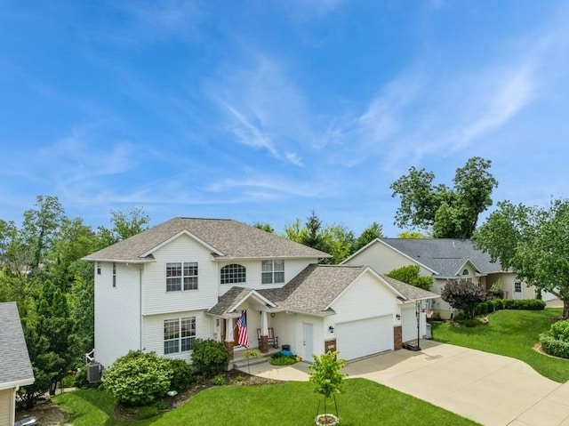 2815 Oak Crest Ct NW, Cedar Rapids, IA 52405 - traditional home featuring a garage, a front lawn, driveway, and roof with shingles