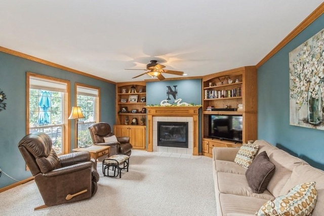 2815 Oak Crest Ct NW, Cedar Rapids, IA 52405 - living area with built in features, a ceiling fan, a tiled fireplace, light carpet, and ornamental molding