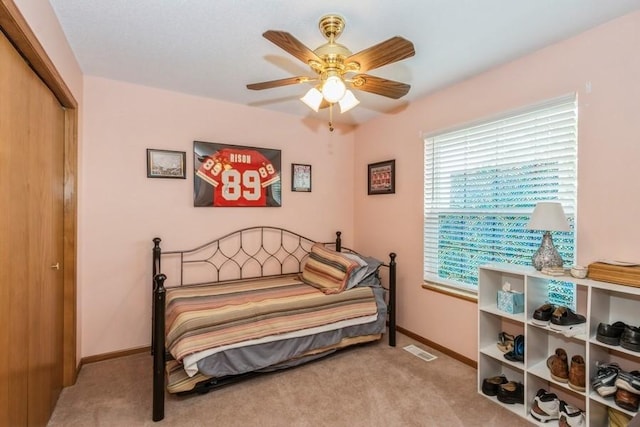 2815 Oak Crest Ct NW, Cedar Rapids, IA 52405 - bedroom with carpet flooring, a closet, and ceiling fan