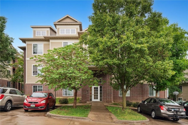 1848 W Benton St, Iowa City, IA 52246 - view of property with french doors, brick siding, and uncovered parking