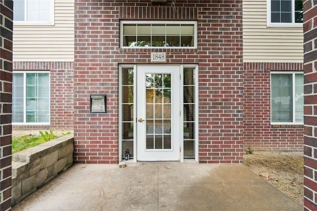 1848 W Benton St, Iowa City, IA 52246 - doorway to property with a patio area and brick siding