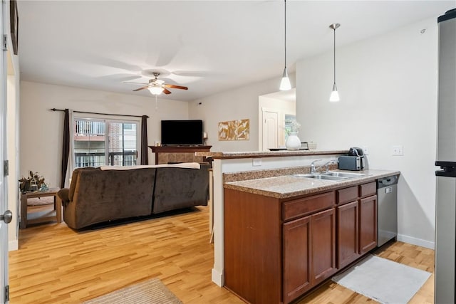 1848 W Benton St, Iowa City, IA 52246 - kitchen with stainless steel dishwasher, ceiling fan, light wood-style flooring, a peninsula, and open floor plan