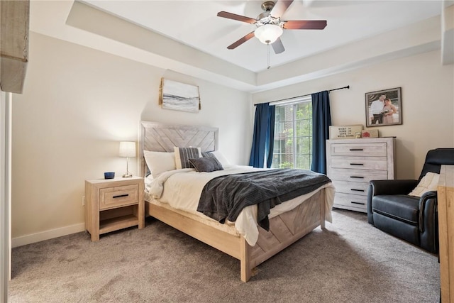 1848 W Benton St, Iowa City, IA 52246 - bedroom featuring a tray ceiling, light carpet, and ceiling fan