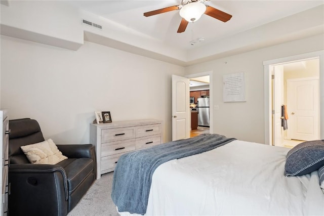 1848 W Benton St, Iowa City, IA 52246 - bedroom featuring freestanding refrigerator, light colored carpet, and a ceiling fan