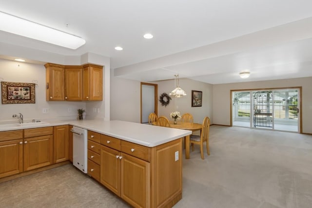 2601 Hickory Trl Unit 1, Iowa City, IA 52245 - kitchen featuring dishwasher, a peninsula, light countertops, brown cabinetry, and recessed lighting