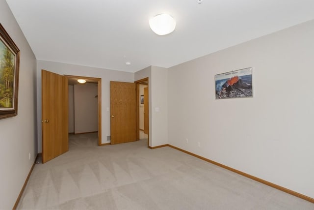 2601 Hickory Trl Unit 1, Iowa City, IA 52245 - unfurnished bedroom with light carpet and a walk in closet