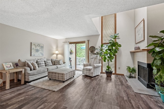 2060 Holiday Rd, Coralville, IA 52241 - living room featuring wood finished floors, a textured ceiling, and a tile fireplace