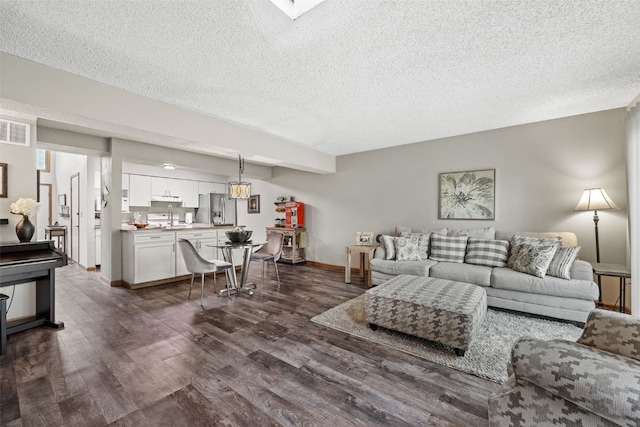 2060 Holiday Rd, Coralville, IA 52241 - living room with dark wood-style floors and a textured ceiling