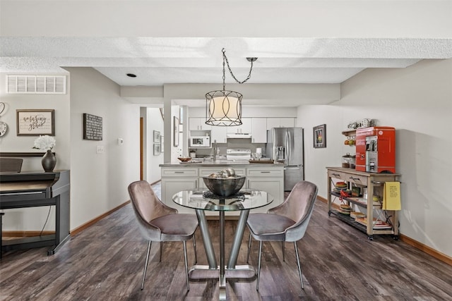 2060 Holiday Rd, Coralville, IA 52241 - dining space with baseboards and dark wood-style flooring