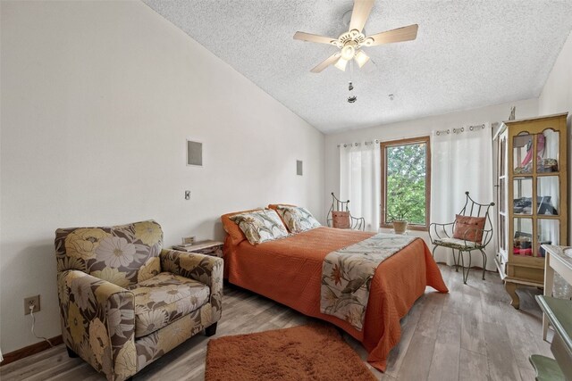 2060 Holiday Rd, Coralville, IA 52241 - bedroom with a textured ceiling, vaulted ceiling, light wood finished floors, and ceiling fan