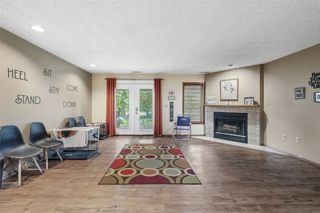 2060 Holiday Rd, Coralville, IA 52241 - living room featuring a textured ceiling, wood finished floors, a fireplace, and recessed lighting