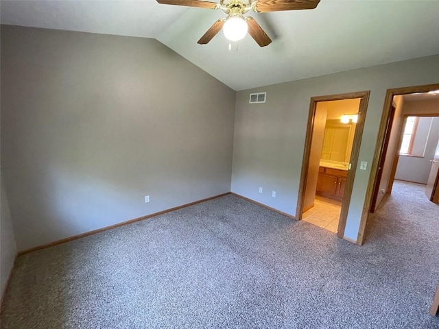 640 Magnolia Ln Unit 1, Marion, IA 52302 - unfurnished bedroom with light carpet, lofted ceiling, a ceiling fan, and ensuite bath