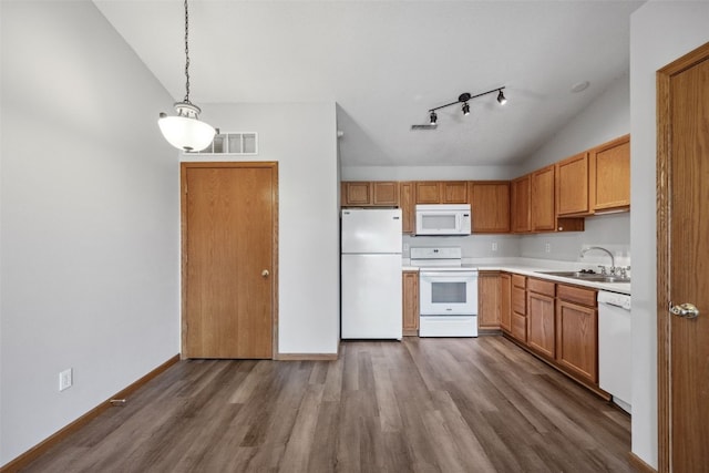 620 Colton Cir NE Unit 11, Cedar Rapids, IA 52402 - kitchen featuring white appliances, lofted ceiling, dark wood-style floors, light countertops, and hanging light fixtures