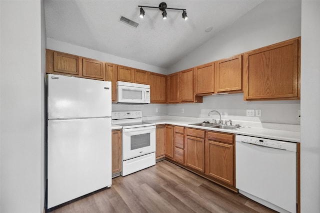 620 Colton Cir NE Unit 11, Cedar Rapids, IA 52402 - kitchen with white appliances, wood finished floors, vaulted ceiling, and light countertops