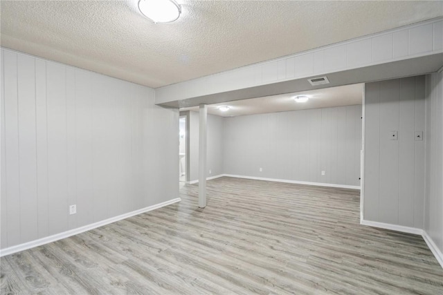705 Grant Wood Dr SE, Cedar Rapids, IA 52403 - finished below grade area featuring wood finished floors and a textured ceiling